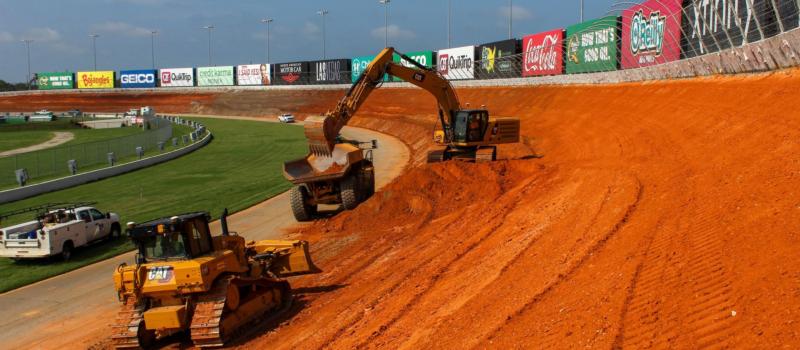 Crews carve into the existing embankment in turns 1 and 2 to give Atlanta Motor Speedway its new 28-degree banked corners.