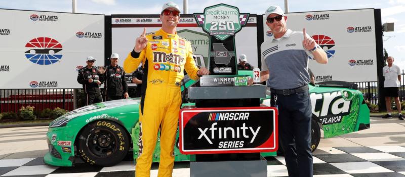 Kyle Busch (left) stands in victory lane with AMS Executive VP & GM Brandon Hutchison (right) after his victory in the Credit Karma Money 250.