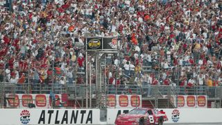 Dale Earnhardt Jr. crosses the start finish line to win in 2004 at AMS,